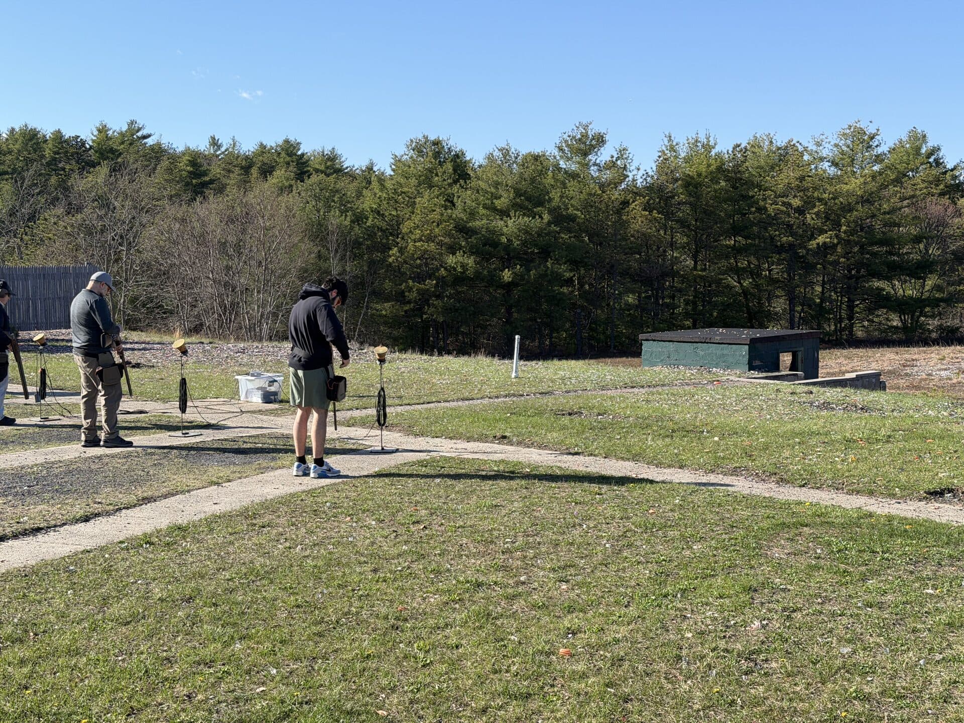 Three shooters on skeet line